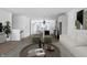 Open-concept living room flowing into the kitchen and dining area, with modern decor and ample natural light at 9891 Baneberry Ln, Carmel, IN 46290