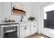 Stylish wet bar featuring modern fixtures, wine fridge, and quartz countertops at 9891 Baneberry Ln, Carmel, IN 46290