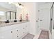 Bright bathroom with a double vanity, granite countertop, and modern fixtures at 9928 Deep Royal Way, Indianapolis, IN 46239