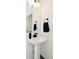 Clean pedestal sink with sleek black hardware and a large mirror in a well-lit bathroom at 9928 Deep Royal Way, Indianapolis, IN 46239