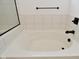 Clean white bathtub with black fixtures in a modern bathroom setting at 9928 Deep Royal Way, Indianapolis, IN 46239