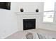 Cozy fireplace with a stone surround and a decorative mantel in a room with plush carpeting at 9928 Deep Royal Way, Indianapolis, IN 46239