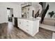 Elegant kitchen island with modern fixtures, white cabinetry and stainless steel dishwasher at 9928 Deep Royal Way, Indianapolis, IN 46239