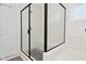 Modern glass-enclosed shower with gray tile flooring and a built-in bench at 9928 Deep Royal Way, Indianapolis, IN 46239