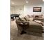 Finished basement area featuring comfortable seating, a side table, and a ping pong table for entertainment at 10118 Leeward Blvd, Indianapolis, IN 46256
