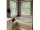 Bright bathroom with a soaking tub and a double window for natural light at 10118 Leeward Blvd, Indianapolis, IN 46256