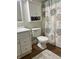 Bathroom features a stylish patterned shower curtain and white cabinets at 10118 Leeward Blvd, Indianapolis, IN 46256