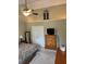 Comfortable bedroom featuring a ceiling fan, a TV, and a decorative window shutter at 10118 Leeward Blvd, Indianapolis, IN 46256