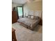 Cozy bedroom featuring a large bed with decorative headboards, bedside tables and a wooden armoire at 10118 Leeward Blvd, Indianapolis, IN 46256