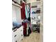 Organized walk-in closet with hanging clothes, shelves and cubbies for optimal storage at 10118 Leeward Blvd, Indianapolis, IN 46256