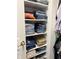 Well-organized closet with shelves stacked with folded jeans and other clothing items at 10118 Leeward Blvd, Indianapolis, IN 46256