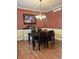 Formal dining room features hardwood floors and elegant chandelier lighting at 10118 Leeward Blvd, Indianapolis, IN 46256