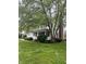Charming two-story home with a manicured lawn, mature trees, and an inviting front porch at 10118 Leeward Blvd, Indianapolis, IN 46256