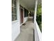 Relax on the covered porch featuring a porch swing for cozy evenings at 10118 Leeward Blvd, Indianapolis, IN 46256