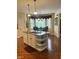 Bright kitchen with a granite island, open shelving and a dining area with a bay window at 10118 Leeward Blvd, Indianapolis, IN 46256