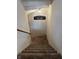 Carpeted staircase leading down, featuring a decorative wall sign and wooden handrail at 10118 Leeward Blvd, Indianapolis, IN 46256