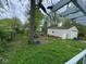 The backyard has a detached garage with white siding and a pleasant green lawn at 10361 E 30Th St, Indianapolis, IN 46229