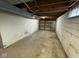 Unfinished basement with concrete walls and floor and an exposed wooden structure at 10361 E 30Th St, Indianapolis, IN 46229