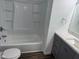 Bathroom featuring a tub with shower, toilet, and vanity with storage at 10361 E 30Th St, Indianapolis, IN 46229