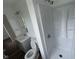 Bathroom with modern shower, gray vanity, sleek sink, and a toilet at 10361 E 30Th St, Indianapolis, IN 46229