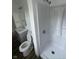 Bathroom featuring a toilet, vanity, and shower with built-in shelving for storage at 10361 E 30Th St, Indianapolis, IN 46229