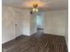 Bedroom with white walls, laminate flooring, a ceiling fan, and an open doorway at 10361 E 30Th St, Indianapolis, IN 46229