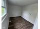 This cozy bedroom features warm wood-look flooring and a sunny window at 10361 E 30Th St, Indianapolis, IN 46229