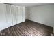 This bedroom boasts wood-look floors and a spacious closet with bi-fold doors at 10361 E 30Th St, Indianapolis, IN 46229