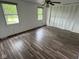 Large bedroom with wood-look floors, ceiling fan, two windows, and large closet at 10361 E 30Th St, Indianapolis, IN 46229