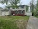 Two-story home with a two car garage and separate single car garage with a red front door at 10361 E 30Th St, Indianapolis, IN 46229