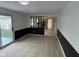 Living room area with wood flooring and access to the kitchen at 10361 E 30Th St, Indianapolis, IN 46229