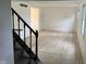 Bright living room featuring wood floors, a staircase and white walls at 10361 E 30Th St, Indianapolis, IN 46229