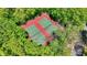 Aerial view of tennis courts surrounded by lush trees, offering a private and scenic recreational space at 10882 Camden Ct, Fishers, IN 46038
