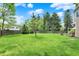 Lush backyard with a view of mature trees and neighboring houses at 10882 Camden Ct, Fishers, IN 46038