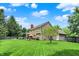 Expansive backyard view of a two-story home with a well-maintained lawn and mature trees at 10882 Camden Ct, Fishers, IN 46038