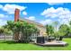 View of backyard featuring a deck, lush lawn, and mature landscaping at 10882 Camden Ct, Fishers, IN 46038