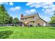 Wide backyard view showcasing the home's layout with a patio area, deck, and lush green lawn at 10882 Camden Ct, Fishers, IN 46038