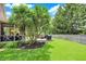 Backyard with a screened-in porch, deck, lush landscaping, and a privacy fence at 10882 Camden Ct, Fishers, IN 46038