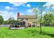 Expansive backyard featuring a deck, patio, and mature landscaping on a sunny day at 10882 Camden Ct, Fishers, IN 46038