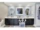 Double sink bathroom with dark cabinets and tile floors at 10882 Camden Ct, Fishers, IN 46038