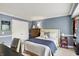 Inviting bedroom with a neutral palette, a wooden dresser, and a cozy sitting area, creating a peaceful and serene ambiance at 10882 Camden Ct, Fishers, IN 46038
