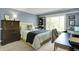 Comfortable bedroom with a large window, a wooden dresser, and stylish decor, creating a welcoming and relaxing space at 10882 Camden Ct, Fishers, IN 46038