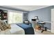 Bright and airy bedroom with a large window, a modern desk, and tasteful decor, providing a comfortable and functional space at 10882 Camden Ct, Fishers, IN 46038