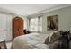 Lovely bedroom showcasing natural light, a wooden armoire, and stylish decor, providing a cozy and inviting retreat at 10882 Camden Ct, Fishers, IN 46038