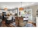 Bright dining area featuring hardwood floors, and a decorative lighting fixture over the round dining table at 10882 Camden Ct, Fishers, IN 46038