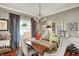 Dining room with hardwood floors, elegant chandelier, and seating for four at 10882 Camden Ct, Fishers, IN 46038