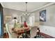 Dining room with hardwood floors, chandelier, and view of the dining room sideboard at 10882 Camden Ct, Fishers, IN 46038