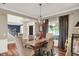 Dining room featuring a dark wood table, wood floors, and a view of the front door at 10882 Camden Ct, Fishers, IN 46038