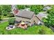 An aerial view showcasing a home's outdoor patio, lush lawn, and landscaping at 10882 Camden Ct, Fishers, IN 46038