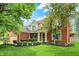 Charming two-story brick home featuring a well-manicured lawn and lush landscaping at 10882 Camden Ct, Fishers, IN 46038